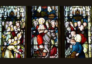 Stained-glass window featuring the scene of Christ's Entry into Jerusalem, Palm Sunday events 
