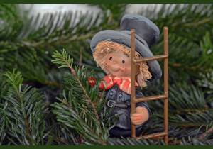 A chimney sweep figurine at the New Year tree, a chimney sweep as a symbol of happiness